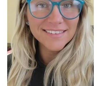 crew member headshot with glasses and blonde hair. 